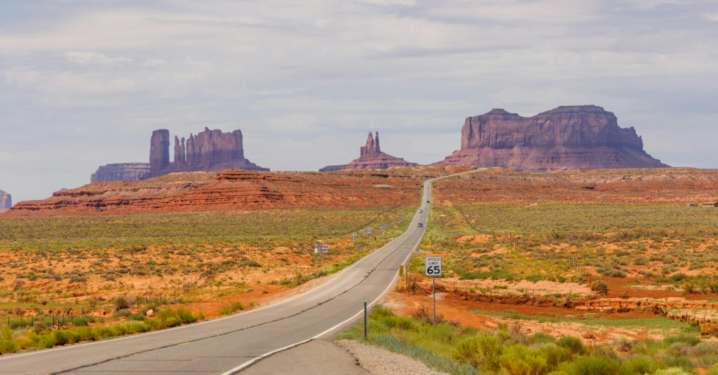Long road leading to mountains in background of southwest landscape
