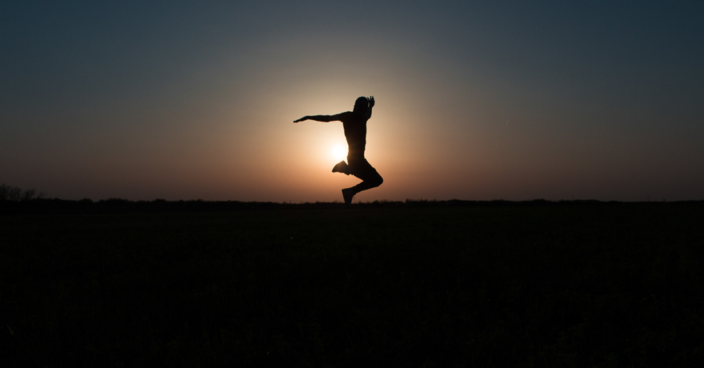 individual jumps with freedom in front of sunlit horizon - anxiety care in Chandler, AZ