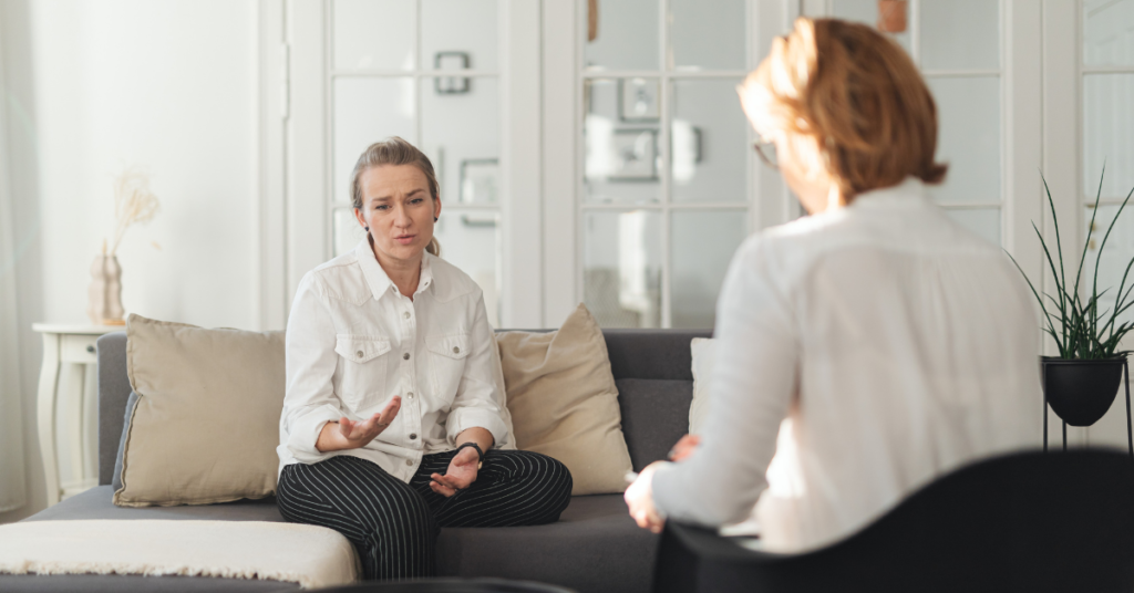 Two individuals discuss mental health in comfortable setting - Ketamine Therapy in Chandler, AZ